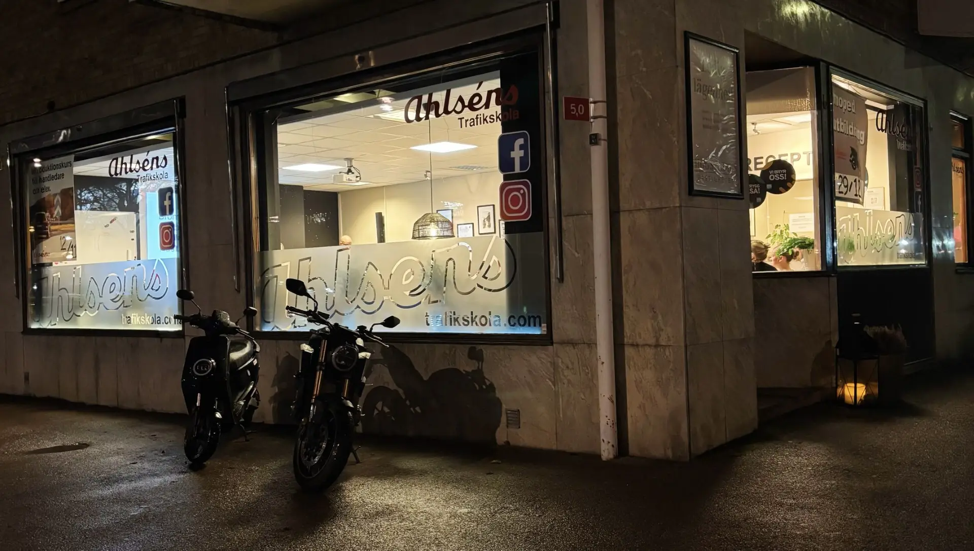 Ahlséns Trafikskolas lokal på Folkungagatan i Mjölby en kväll, med en moped och en motorcykel utanför